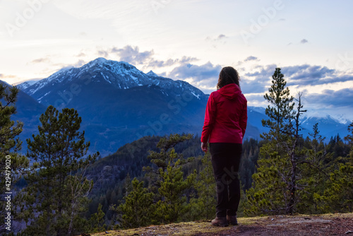 Adventurous Woman Hiking in the mountains during a Spring Sunset. Taken Squamish, North of Vancouver, British Columbia, Canada. Concept: Adventure, freedom, lifestyle
