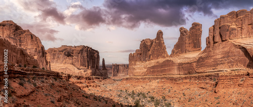 Panoramic American landscape view of Scenic red rock canyons. Artistic Sky Colorful Render. Taken in Arches National Park, located near Moab, Utah, United States. Nature Background Panorama