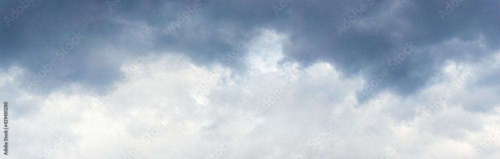 Panorama of cloudy sky with dark clouds at the top and light at the bottom