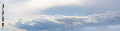 Fototapeta Naklejka Na Ścianę i Meble -  Panorama of a cloudy sky with clouds arranged in a row