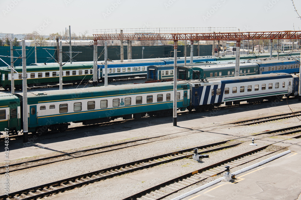 Fototapeta premium Parking for diesel electric locomotive. Vintage green train cars at the station.