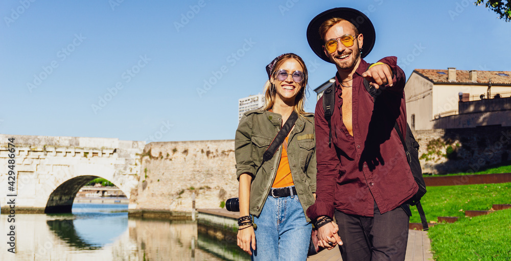 Couple of tourists is exploring new city together -