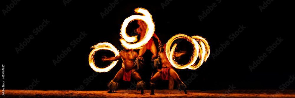 Luau hawaiian fire dancers motion blur tourist attraction in Hawaii or French Polynesia, traditional polynesian dance with men dancer. - obrazy, fototapety, plakaty 
