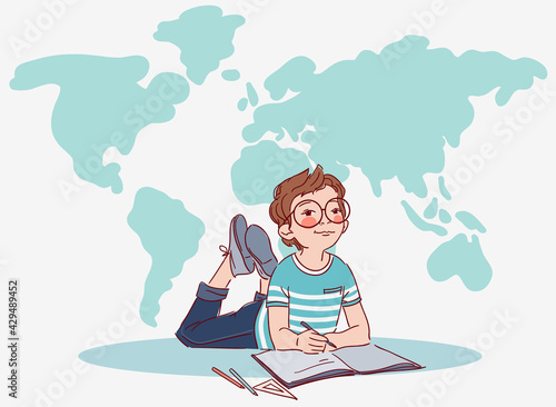 Little, cute boy writing in notebook. World map background