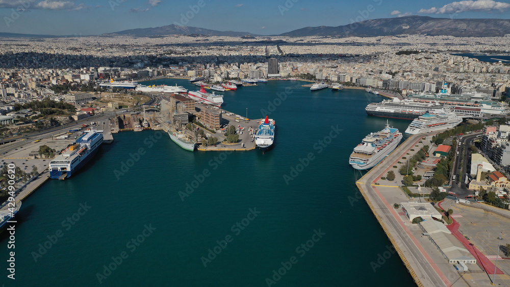 Fototapeta premium Aerial drone panoramic photo of famous and busy port of Piraeus where passenger ships travel to popular Aegean destinations, Attica, Greece