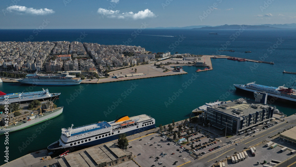 Aerial drone panoramic photo of famous and busy port of Piraeus where passenger ships travel to popular Aegean destinations, Attica, Greece