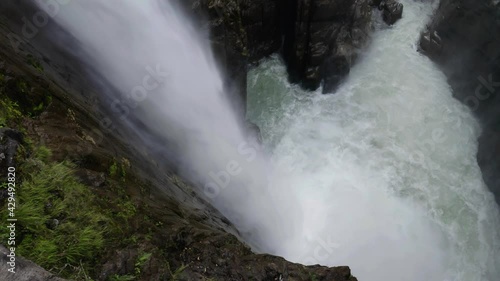 Sideview of a large cascade with the water plunging down, a tropical paradise 