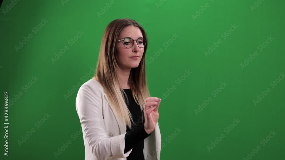 Young woman taps on a large imaginary touchscreen - studio photography Young woman taps on a large imaginary touchscreen - studio photography