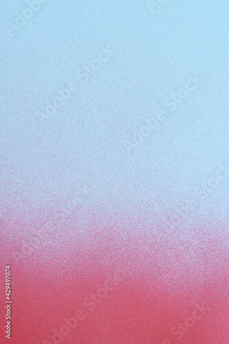 redspray paint on a soft blue colored paper background