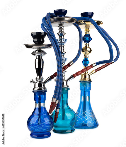 Oriental hookahs in blue glass vases and hoses.