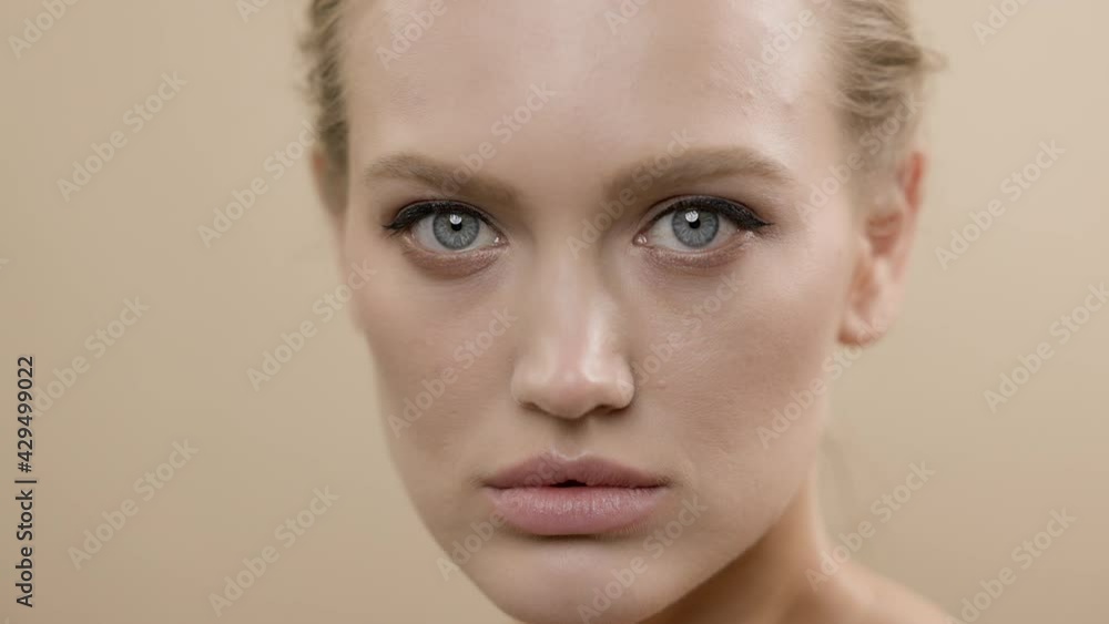 Model Posing In Front Of The Camera. Face Of Blonde Girl With Serious Expression. Model Posing In Front Of The Camera. Face Of Blonde Girl With Serious Expression.