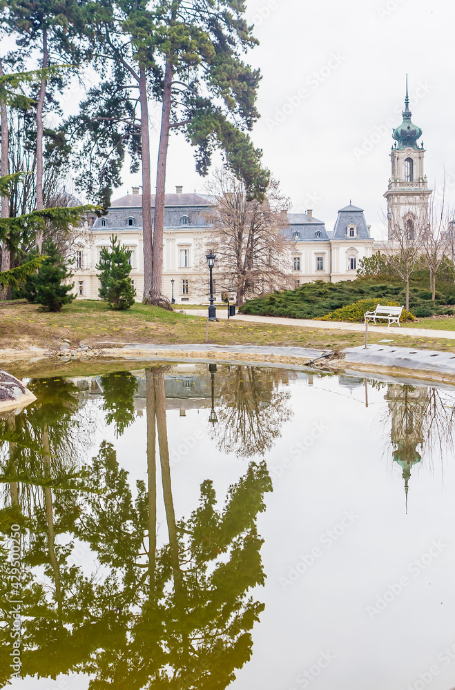 Green park with a view of the Beautiful baroque Festetics Castle in Keszthely Hungary, reflection in the lake pond