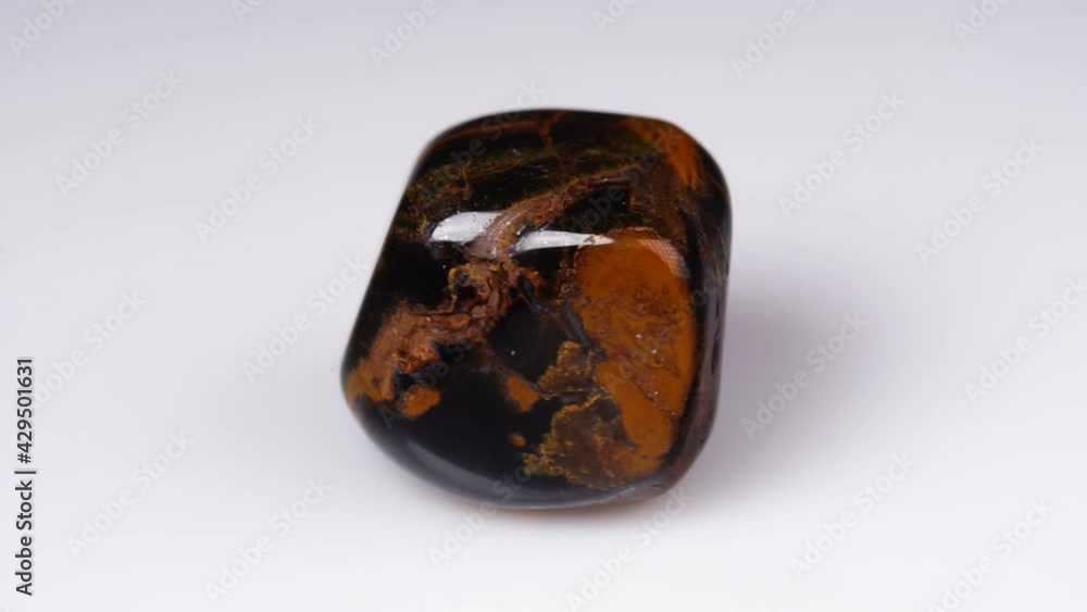 natural jaspelite gemstone on the white background on the turning table natural jaspelite gemstone on the white background on the turning table