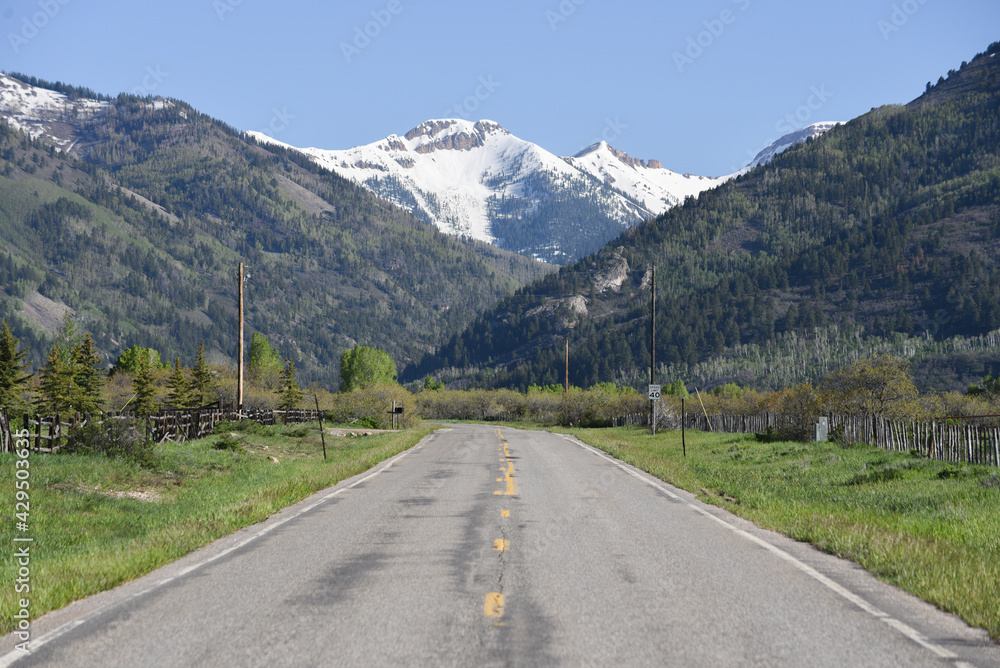 a country road heading into the mountains