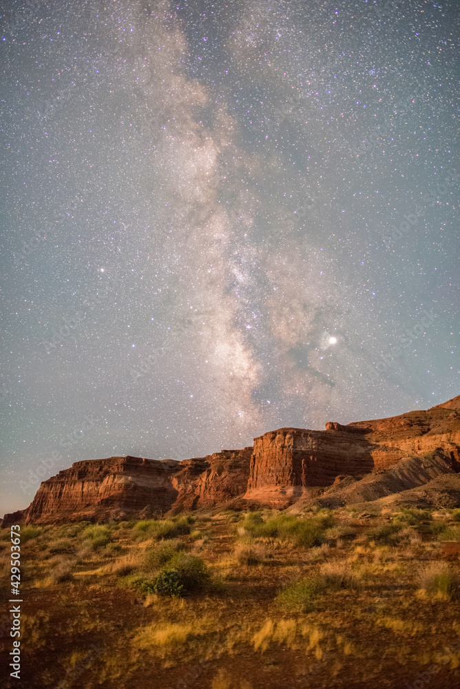 The milky way core rising over a desert landscape