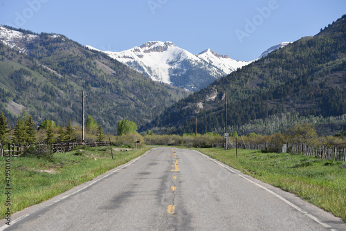a country road heading into the mountains