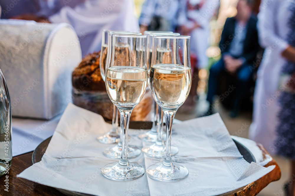 Glasses with white sparkling wine on a tray Glasses with white sparkling wine on a tray