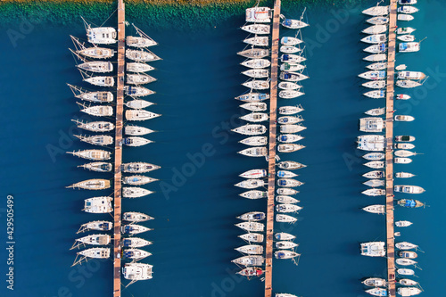 Yacht club with yachts docked in marine bay in Turkey. Aerial top view of sailboats in lagoon