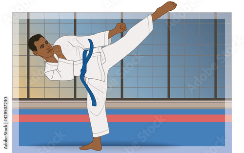karate male side kick stance on mat with dojo in the background