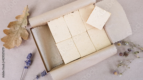 apple pastille in a beautiful cardboard box on the background of autumn leaves and flowers photo