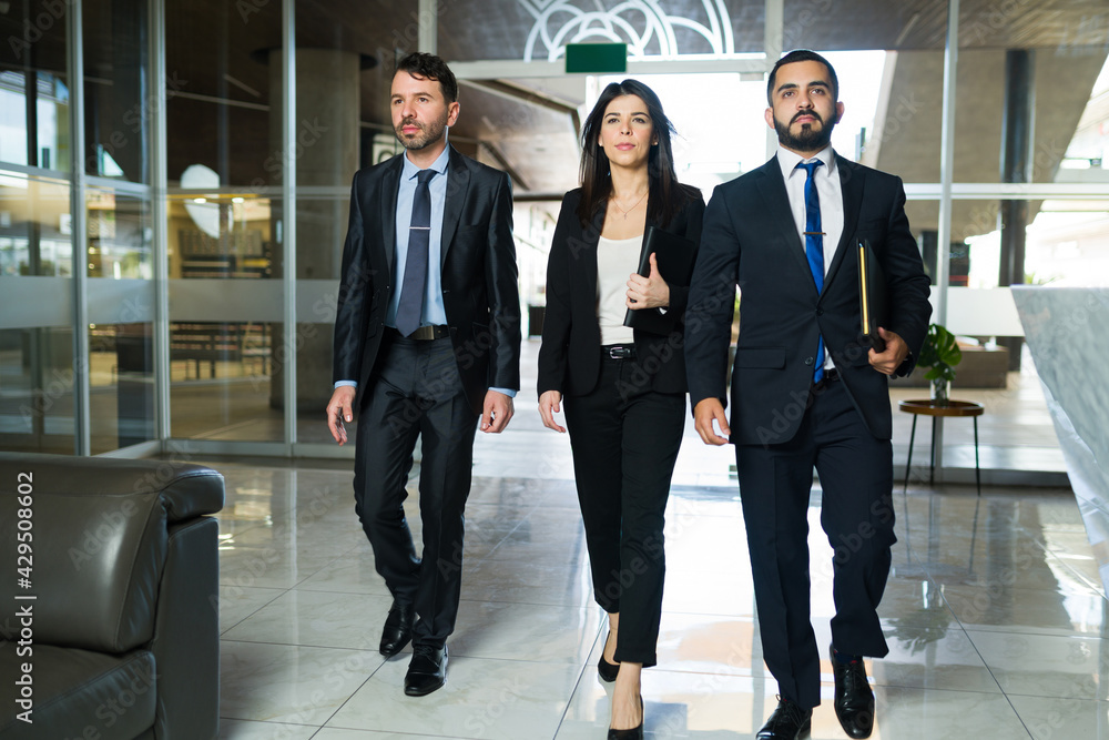 Business executives walking to their offices Business executives walking to their offices