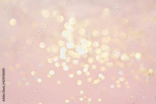 Golden bokeh on pastel pink background - copy space