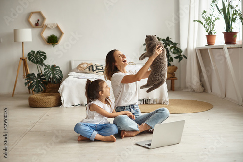 daughter watching mom work on computer