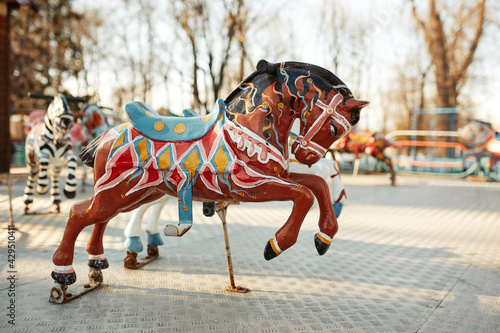 Soviet abandoned amusement park. Vintage carousel horses. A traditional fairground carousel photo