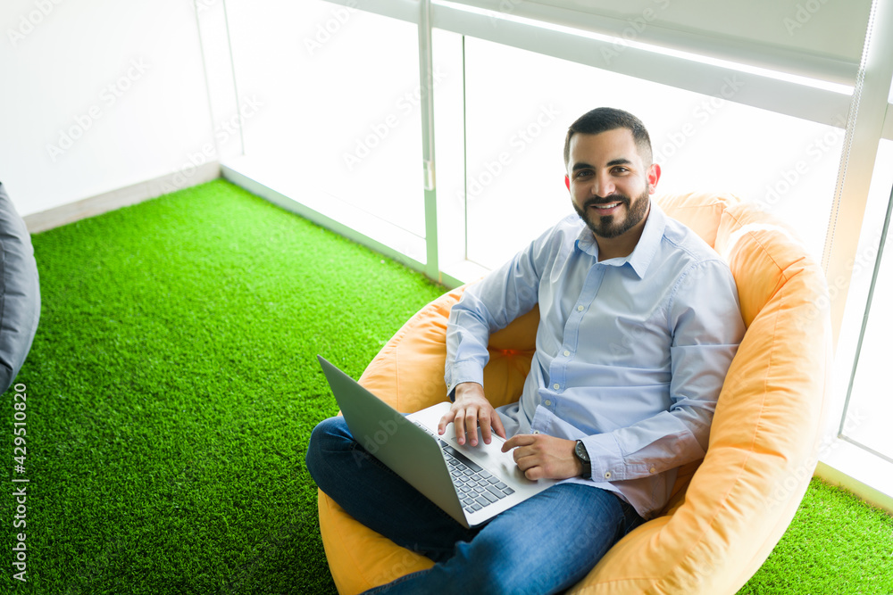 Co-worker resting in a comfy chair in his workplace Co-worker resting in a comfy chair in his workplace