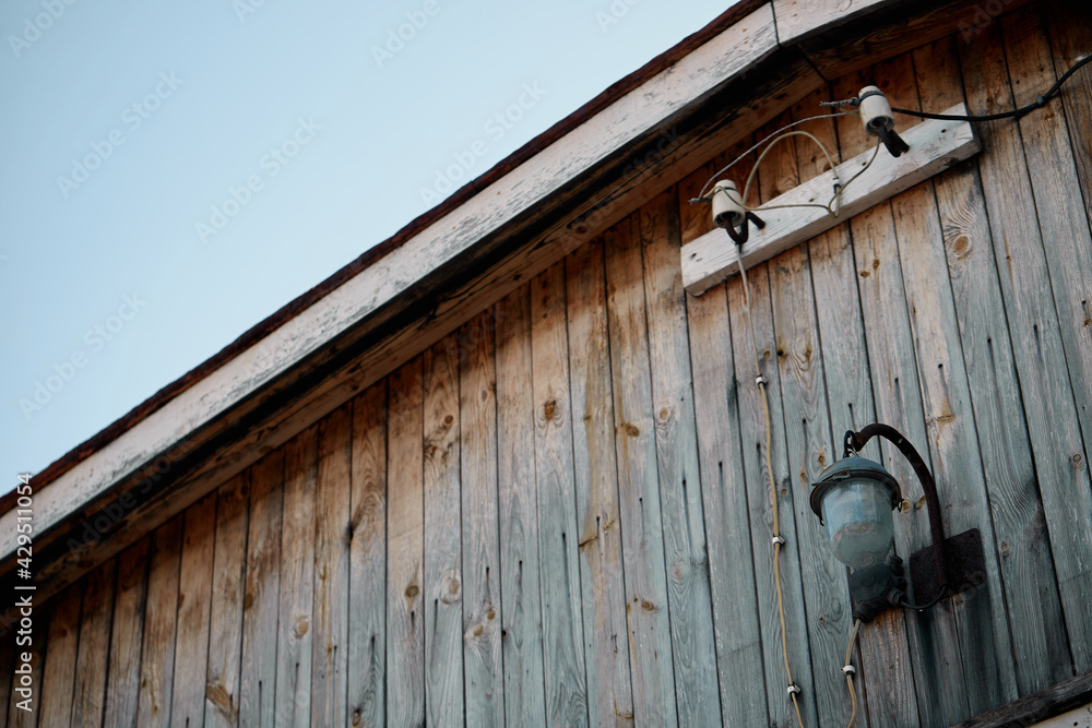 Wooden roof wing with vintage lantern and electrical wiring in perspective