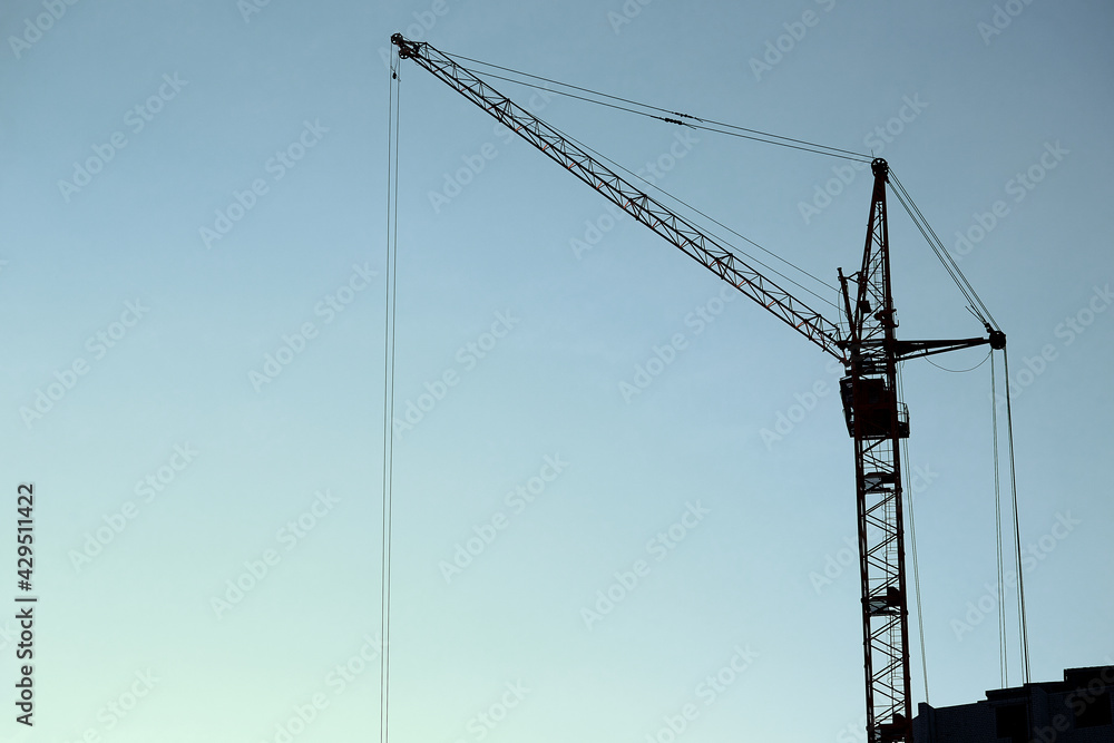 silhouette of a construction crane against the blue sky, panoramic view silhouette of a construction crane against the blue sky, panoramic view