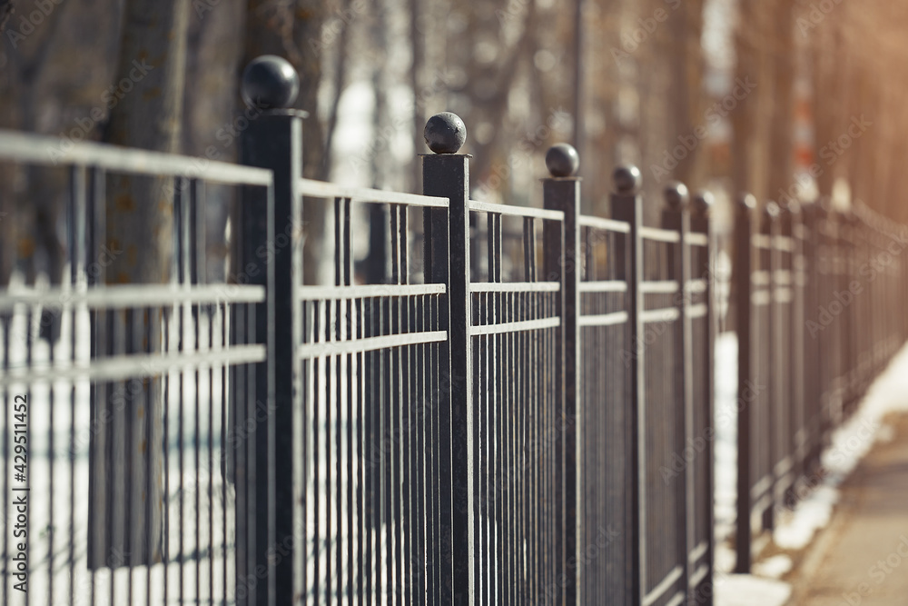 Metal fence in perspective in the park in the spring in the solar reflex Metal fence in perspective in the park in the spring in the solar reflex