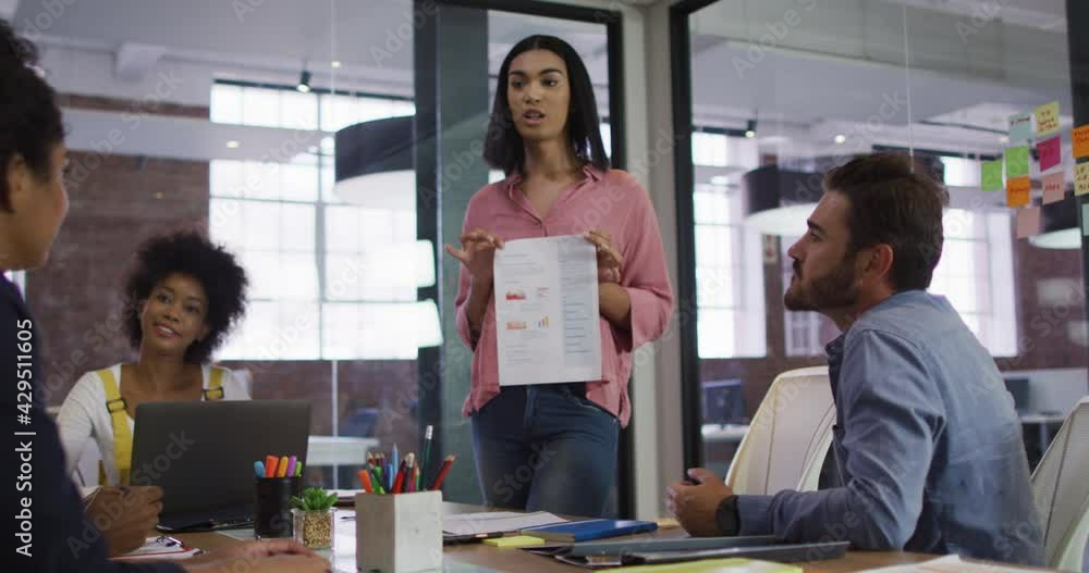 Mixed race businesswoman having a meeting with colleagues in meeting room Mixed race businesswoman having a meeting with colleagues in meeting room