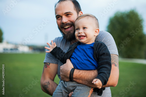 Happy father and his little son are having fun in the park. Beautiful family is spending time together outside.