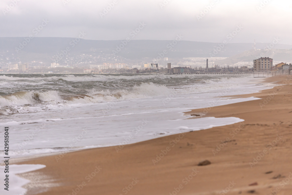 Deserted beaches of Feodosia in winter. Wide beach and storm at sea. A beach that is waiting for tourists, but is still empty. Deserted beaches of Feodosia in winter. Wide beach and storm at sea. A beach that is waiting for tourists, but is still empty.