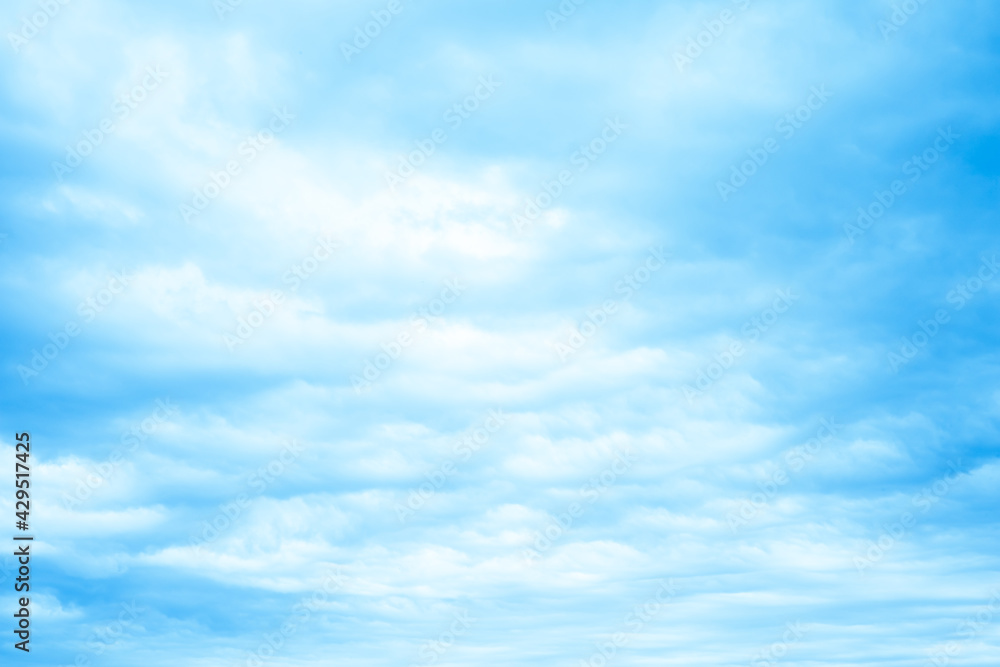Bright blue sky with fluffy cumulus clouds floating in sunny day. Pure white cloudscape scene with natural sunlight, beautiful abstract freedom shape in the air. Cloudy space view background in summer