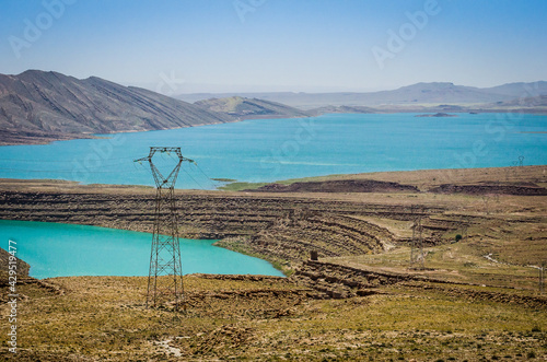 Turquoise blue water in Barrage Al-Hassan Addakhil in dry nature near Errachidia in Morocco photo