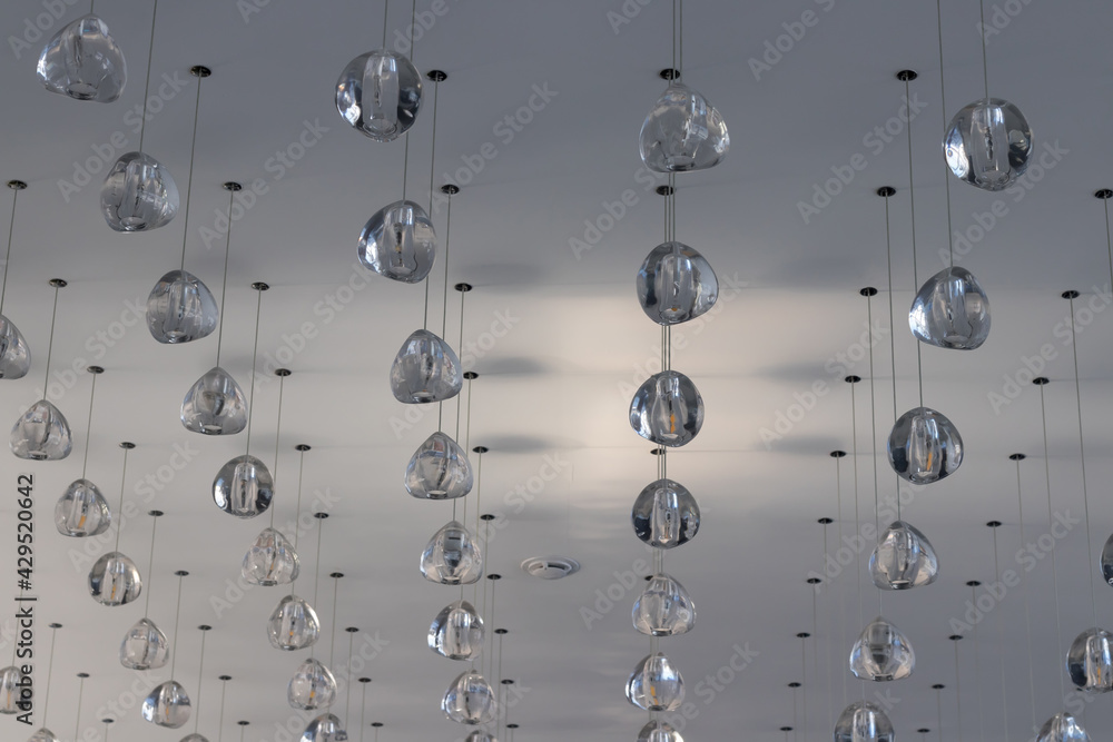 Obraz premium A lot of simple shapes of lamps on the ceiling in a room not at home