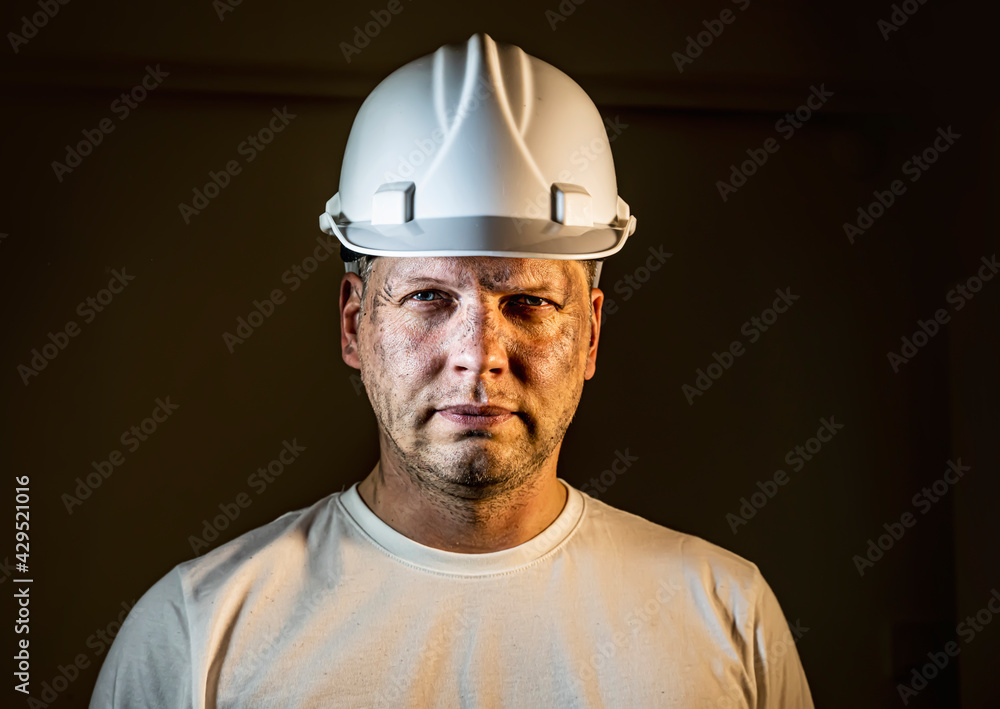 working man construction worker with dirty face looking at camera Close up portrait working man construction worker with dirty face looking at camera Close up portrait