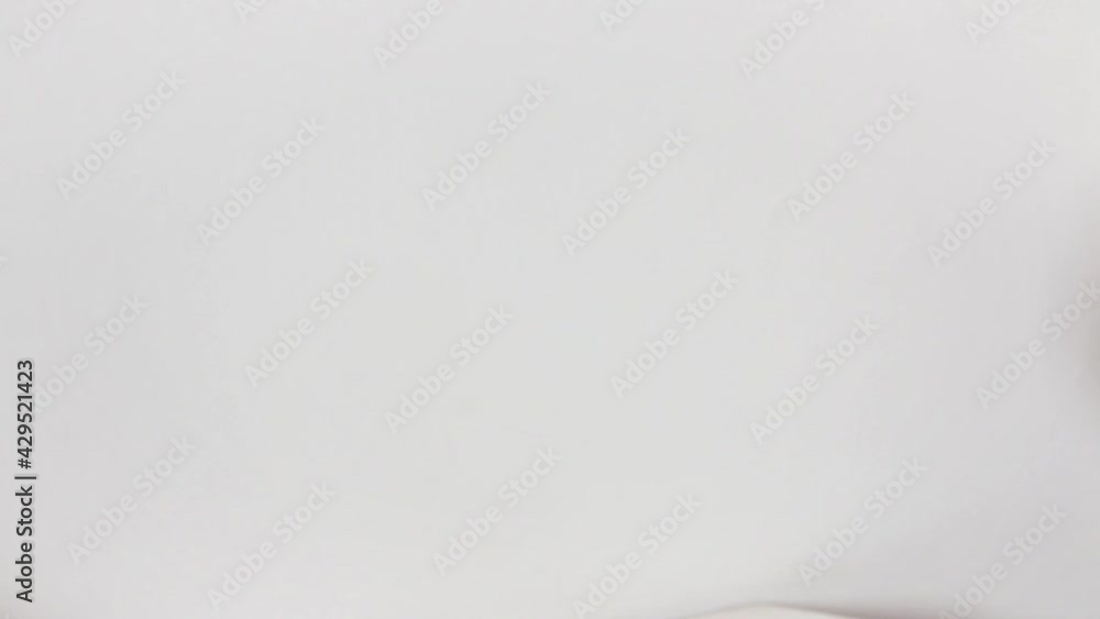 Caucasian woman's hand offers a 1000 argentine money block in close-up and white background Caucasian woman's hand offers a 1000 argentine money block in close-up and white background