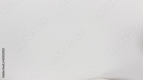 Caucasian woman's hand offers a 1000 argentine money block in close-up and white background