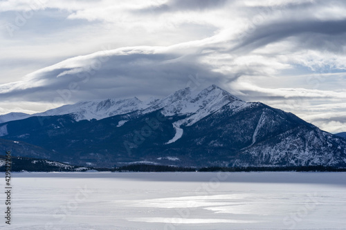 Clouds over mountain peaks at frozen LakeDillon Colorado on partly cloudy but nice winter day