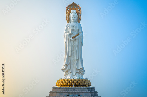 Beautiful front view of 108m high Guanyin of the South Sea statue of Nanshan Buddhism cultural park temple at sunrise in Sanya Hainan island China photo