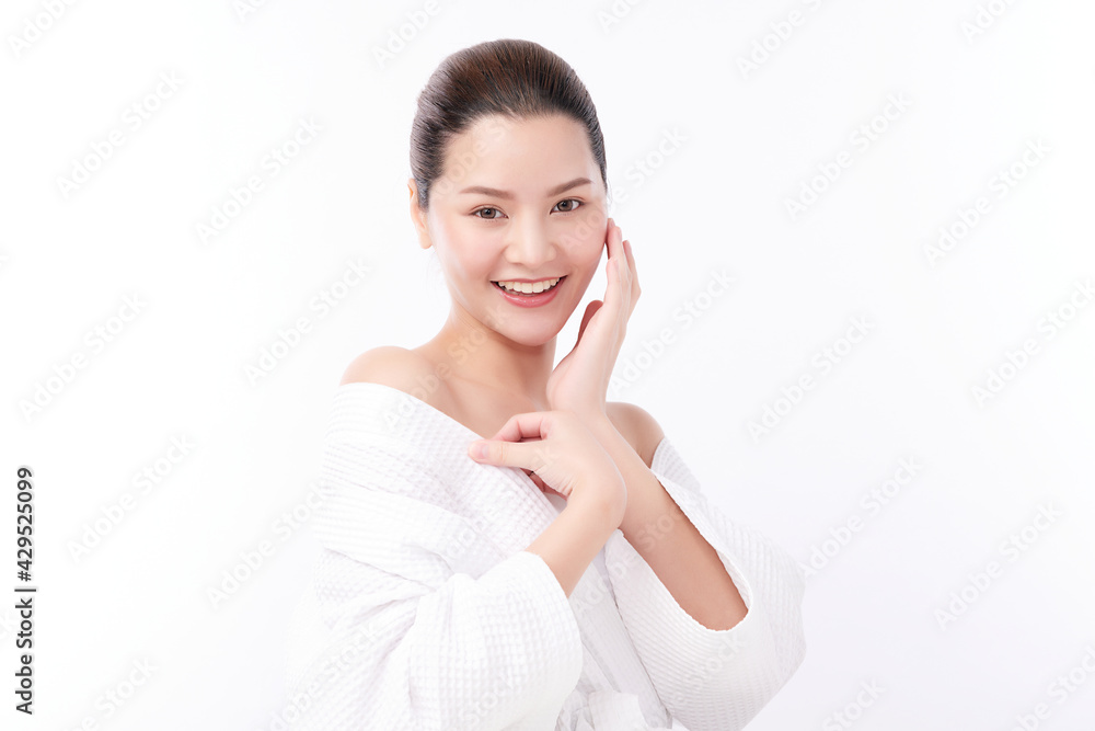 Beautiful young Asian woman wearing bathrobe on white background, Face care, Facial treatment, Cosmetology, beauty and spa Concept. Beautiful young Asian woman wearing bathrobe on white background, Face care, Facial treatment, Cosmetology, beauty and spa Concept.