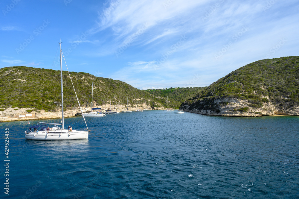 Panoramic view of the bay with mountains against blue sky with clouds. White yacht in the foreground. Horizontal view Panoramic view of the bay with mountains against blue sky with clouds. White yacht in the foreground. Horizontal view