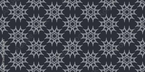 Stylish background patterns with gray geometric ornament on a black background, wallpaper. Seamless pattern, texture. Vector graphics