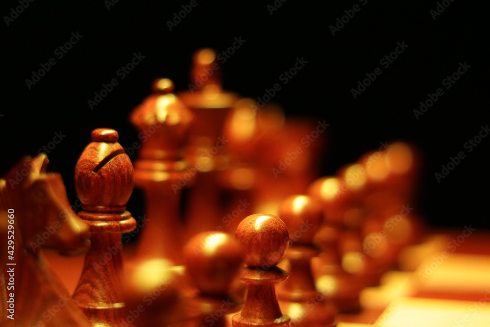 Chess pieces with Bishop in focus on chess board