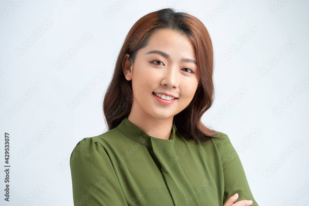 Portrait of a happy woman standing with arms folded isolated on a white background Portrait of a happy woman standing with arms folded isolated on a white background