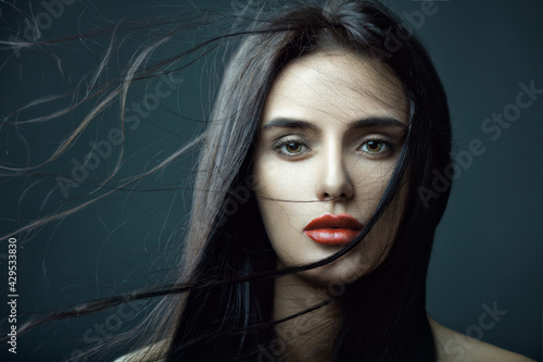 Closeup beauty portrait of a sexy brunette girl with flying hair. Magnificent hair.