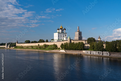 Bank of the Velikaya river. Installation "Russia begins here". Pskov Kremlin in the morning. Trinity cathedral, Pskov, Russia